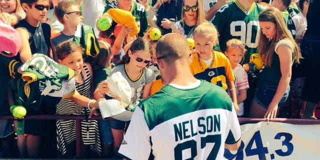 Green Bay Packers receiver Jordy Nelson signs autographs after his annual charity softball game.