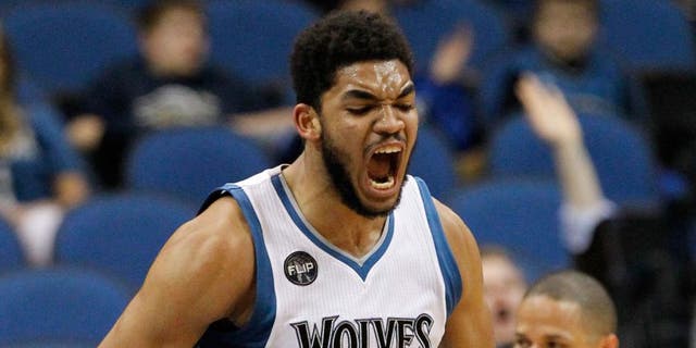 Minnesota Timberwolves center Karl-Anthony Towns reacts after making a shot.