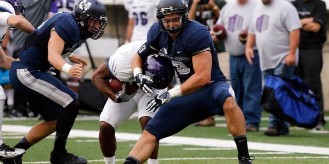 Sep 14, 2013; Logan, UT, USA; Utah State Aggies linebacker Kyler Fackrell (9) tackles Weber State Wildcats running back Josh Booker (24) during the second quarter at Romney Stadium. Mandatory Credit: Chris Nicoll-USA TODAY Sports
