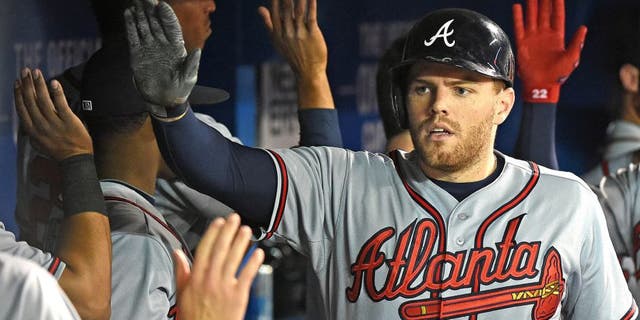 Apr 18, 2015; Toronto, Ontario, CAN; Atlanta Braves first baseman Freddie Freeman (5) is greeted by teammates after hitting a two-run home run against Toronto Blue Jays in the third inning at Rogers Centre. Mandatory Credit: Dan Hamilton-USA TODAY Sports