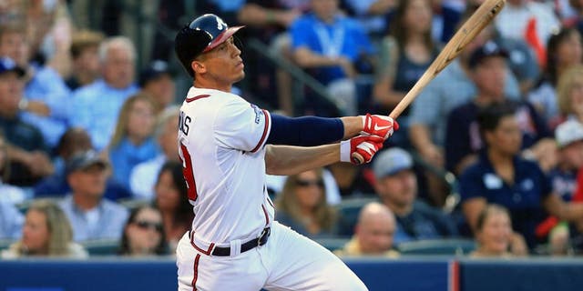 Oct 4, 2013; Atlanta, GA, USA; Atlanta Braves shortstop Andrelton Simmons (19) hits an RBI double against the Los Angeles Dodgers during the second inning of game two of the National League divisional series playoff baseball game at Turner Field. Mandatory Credit: Daniel Shirey-USA TODAY Sports