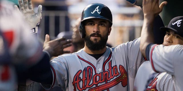 Sep 9, 2015; Philadelphia, PA, USA; Atlanta Braves right fielder Nick Markakis (22) celebrates in the dugout after scoring against the Philadelphia Phillies during the first inning at Citizens Bank Park. Mandatory Credit: Bill Streicher-USA TODAY Sports