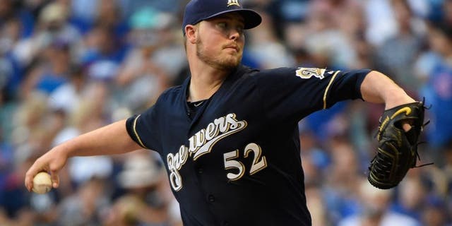 Jul 30, 2015; Milwaukee, WI, USA; Milwaukee Brewers pitcher Jimmy Nelson (52) pitches in the first inning against the Chicago Cubs at Miller Park. Mandatory Credit: Benny Sieu-USA TODAY Sports