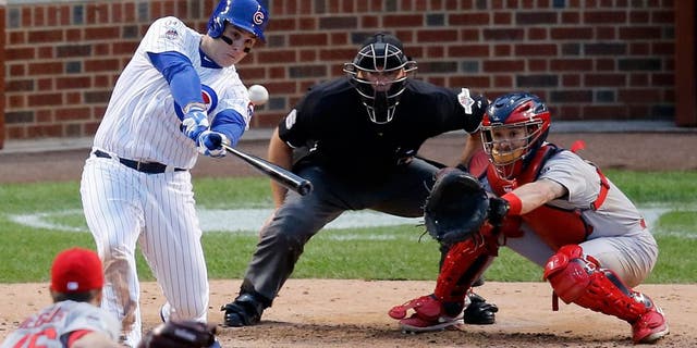 Chicago Cubs' Anthony Rizzo (44) hits a home run against the St. Louis Cardinals during the sixth inning of Game 4 in baseball's National League Division Series, Tuesday, Oct. 13, 2015, in Chicago. (AP Photo/Charles Rex Arbogast)