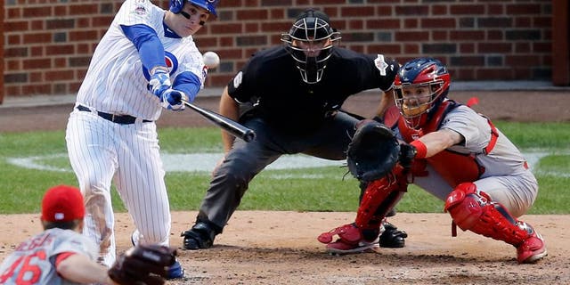 Chicago Cubs' Anthony Rizzo (44) hits a home run against the St. Louis Cardinals during the sixth inning of Game 4 in baseball's National League Division Series, Tuesday, Oct. 13, 2015, in Chicago. (AP Photo/Charles Rex Arbogast)
