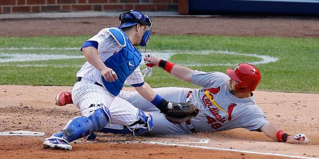 Chicago Cubs catcher Miguel Montero (47) tags out St. Louis Cardinals' Tony Cruz (48) during the sixth inning of Game 4 in baseball's National League Division Series, Tuesday, Oct. 13, 2015, in Chicago. (AP Photo/Charles Rex Arbogast)