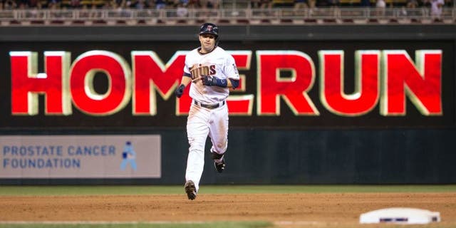 Jun 22, 2015; Minneapolis, MN, USA; Minnesota Twins second baseman Brian Dozier rounds second base after hitting a home run in the eighth inning against the Chicago White Sox at Target Field.