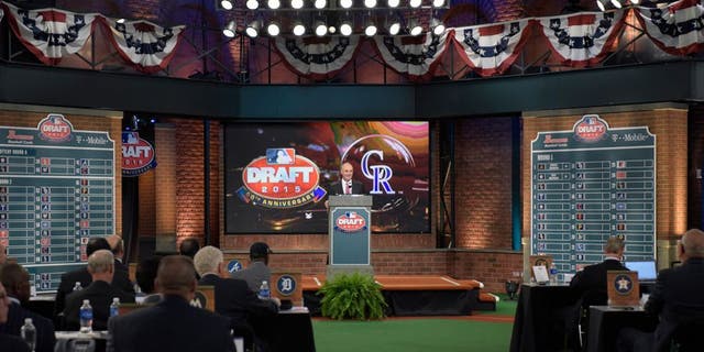 Commissioner of Major League Baseball Rob Manfred announces the third selection at the 2015 MLB baseball draft Monday, June 8, 2015, in Secaucus, N.J. Brendan Rodgers was chosen by the Colorado Rockies with the third selection. (AP Photo/Bill Kostroun)