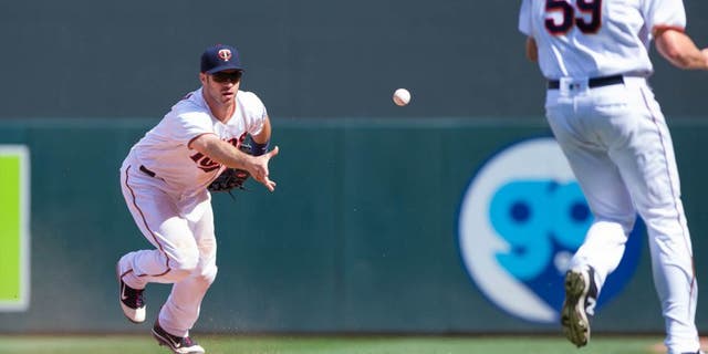 Minnesota Twins first baseman Joe Mauer (left) tosses the ball to relief pitcher Michael Tonkin for an out in the 10th inning against the Boston Red Sox at Target Field in Minneapolis on June 12, 2016. The Twins won 7-4 in 10 innings.