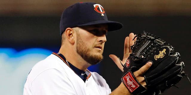 Minnesota Twins pitcher Glen Perkins applauds as the Boston Red Soxâs Xander Bogaerts flies out to end the baseball game as the Twins defeated the Red Sox 2-1, Tuesday, May 26, 2015, in Minneapolis. Perkins picked up the save.