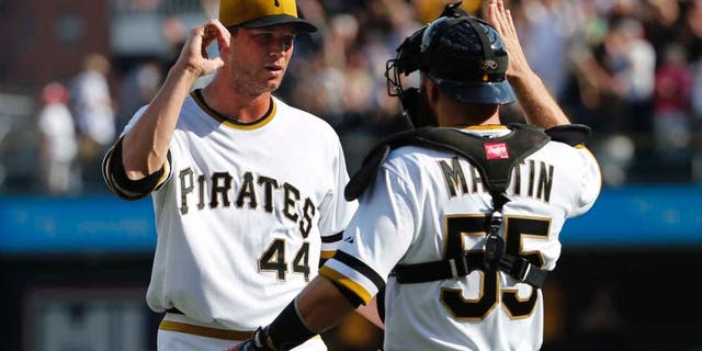 Sunday, September 21: Pittsburgh Pirates relief pitcher Tony Watson (left) celebrates with catcher Russell Martin after getting the final out of the ninth inning. The Pirates won 1-0.