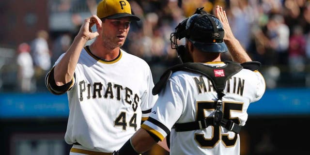 Sunday, September 21: Pittsburgh Pirates relief pitcher Tony Watson (left) celebrates with catcher Russell Martin after getting the final out of the ninth inning. The Pirates won 1-0.
