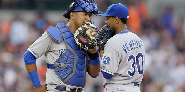 Kansas City Royals catcher Salvador Perez, left, talks with starting pitcher Yordano Ventura during the second inning of a baseball game against the Detroit Tigers, Friday, May 8, 2015, in Detroit. (AP Photo/Carlos Osorio)