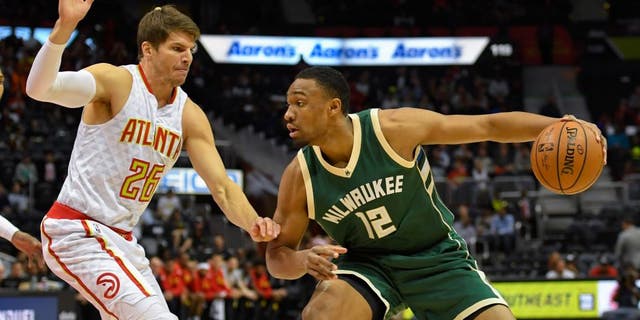 Nov 16, 2016; Atlanta, GA, USA; Milwaukee Bucks forward Jabari Parker (12) dribbles the ball in front of Atlanta Hawks guard Kyle Korver (26) during the first half at Philips Arena. Mandatory Credit: Dale Zanine-USA TODAY Sports