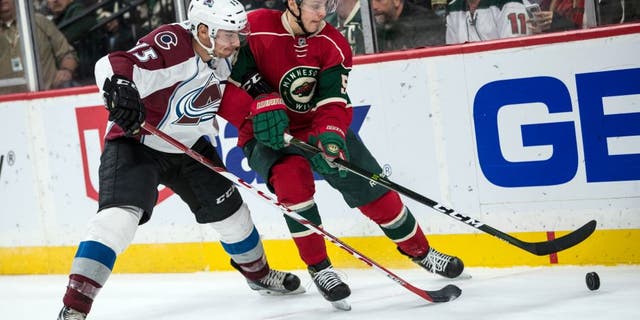 Sep 27, 2016; Saint Paul, MN, USA; Minnesota Wild forward Joel Eriksson Ek (54) protects the puck from Colorado Avalanche defenseman Duncan Siemens (15) during the second period of a preseason hockey game at Xcel Energy Center. Mandatory Credit: Brace Hemmelgarn-USA TODAY Sports