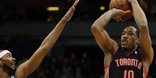Toronto Raptors guard DeMar DeRozan (right) shoots against Minnesota Timberwolves guard Corey Brewer in the first half.