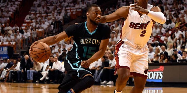 May 1, 2016; Miami, FL, USA; Charlotte Hornets guard Kemba Walker (15) drives to the basket as Miami Heat forward Joe Johnson (2) defends during the first half in game seven of the first round of the NBA Playoffs at American Airlines Arena. Mandatory Credit: Steve Mitchell-USA TODAY Sports
