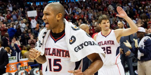 Atlanta Hawks' Al Horford, left, celebrates along with teammate Kyle Korver, right, after they defeated the Oklahoma City Thunder 103-93 to set a franchise record for most consecutive wins at 15 in an NBA basketball game, Friday, Jan. 23, 2015, in Atlanta. (AP Photo/David Goldman)