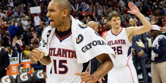 Atlanta Hawks' Al Horford, left, celebrates along with teammate Kyle Korver, right, after they defeated the Oklahoma City Thunder 103-93 to set a franchise record for most consecutive wins at 15 in an NBA basketball game, Friday, Jan. 23, 2015, in Atlanta. (AP Photo/David Goldman)