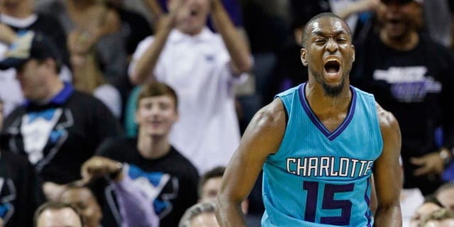 Charlotte Hornets' Kemba Walker (15) reacts after making a basket against the Milwaukee Bucks during the second half of an NBA basketball game in Charlotte, N.C., Wednesday, Oct. 29, 2014. The Hornets won 108-106 in overtime. (AP Photo/Chuck Burton)