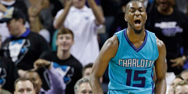 Charlotte Hornets' Kemba Walker (15) reacts after making a basket against the Milwaukee Bucks during the second half of an NBA basketball game in Charlotte, N.C., Wednesday, Oct. 29, 2014. The Hornets won 108-106 in overtime. (AP Photo/Chuck Burton)