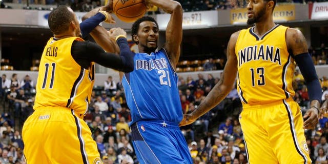 Dec 16, 2015; Indianapolis, IN, USA; Dallas Mavericks forward Jeremy Evans (21) is guarded by Indiana Pacers guard Monta Ellis (11) and forward Paul George (13) at Bankers Life Fieldhouse. Indiana defeats Dallas 107-81. Mandatory Credit: Brian Spurlock-USA TODAY Sports