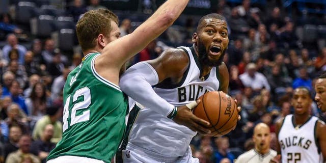 Milwaukee Bucks center Greg Monroe looks for a shot against Boston Celtics forward David Lee in the second quarter at BMO Harris Bradley Center in Milwaukee on Nov. 10, 2015.