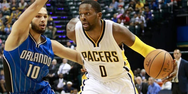 Indiana Pacers forward C.J. Miles (0) drives past Orlando Magic guard Evan Fournier in the second half of an NBA preseason basketball game, Thursday, Oct. 8, 2015, in Indianapolis. Indiana won 97-92. (AP Photo/R Brent Smith)
