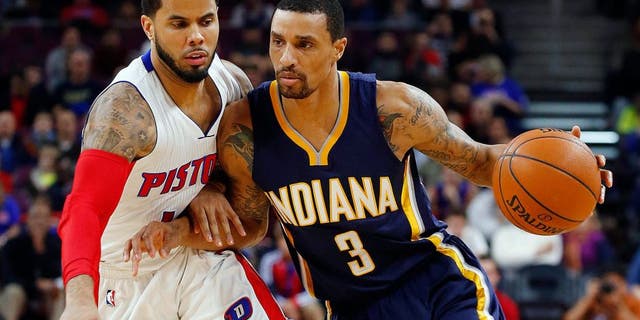 Indiana Pacers guard George Hill (3) drives against Detroit Pistons guard D.J. Augustin (14) in the first half of an NBA basketball game in Auburn Hills, Mich., Friday, Dec. 26, 2014. (AP Photo/Paul Sancya)