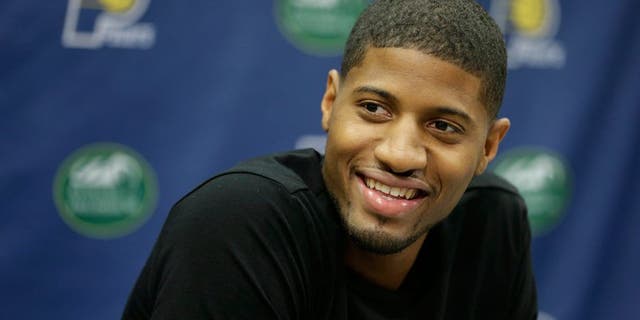 Indiana Pacers' Paul George responds to a question during a news conference Friday, Aug. 15, 2014, in Indianapolis. George hopes to make it back on the court next season despite the "freak accident" that caused a compound fracture in his right leg. (AP Photo/Darron Cummings)
