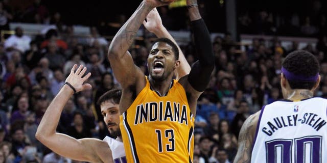 Indiana Pacers forward Paul George (13) is fouled by Sacramento Kings defender Omri Casspi, rear, during the second half of an NBA basketball game in Sacramento, Calif., on Saturday, Jan. 23, 2016. The Kings won 108-97. (AP Photo/Steve Yeater)