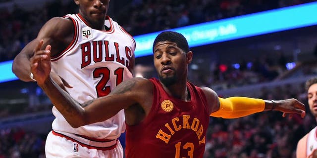 Dec 30, 2015; Chicago, IL, USA; Indiana Pacers forward Paul George (13) knocks the ball away from Chicago Bulls guard Jimmy Butler (21) during the second half at the United Center. Mandatory Credit: Mike DiNovo-USA TODAY Sports