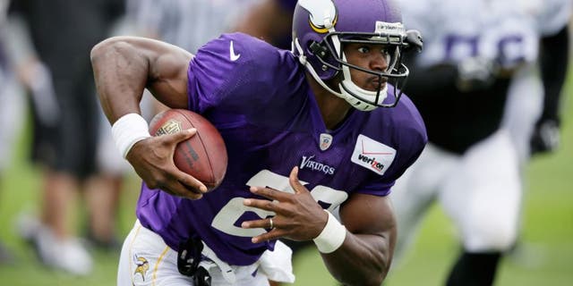 Minnesota Vikings running back Adrian Peterson runs up field during NFL football training camp, Sunday, July 27, 2014, in Mankato, Minn. (AP Photo/Charlie Neibergall)