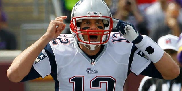 New England Patriots quarterback Tom Brady yells on the line of scrimmage during the first quarter.
