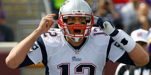 New England Patriots quarterback Tom Brady yells on the line of scrimmage during the first quarter.