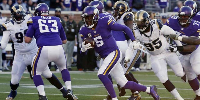 Minnesota Vikings quarterback Teddy Bridgewater breaks away from St. Louis Rams defensive end William Hayes for a touchdown run during the second half of an NFL football game Sunday, Nov. 8, 2015, in Minneapolis.