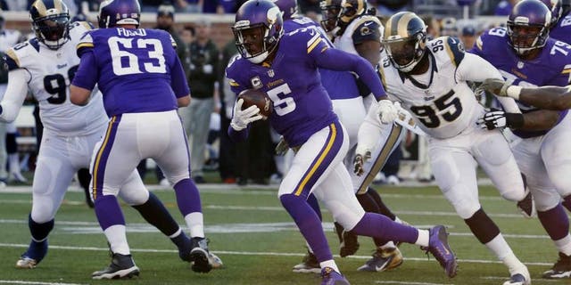 Minnesota Vikings quarterback Teddy Bridgewater breaks away from St. Louis Rams defensive end William Hayes for a touchdown run during the second half of an NFL football game Sunday, Nov. 8, 2015, in Minneapolis.