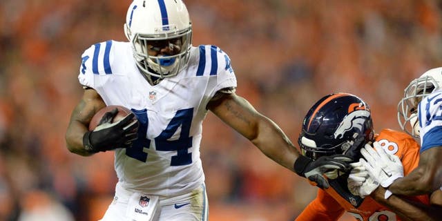 Sep 7, 2014; Denver, CO, USA; Indianapolis Colts running back Ahmad Bradshaw (44) stiff arms Denver Broncos outside linebacker Von Miller (58) in the third quarter at Sports Authority Field at Mile High. The Broncos defeated the Colts 31-24. Mandatory Credit: Ron Chenoy-USA TODAY Sports