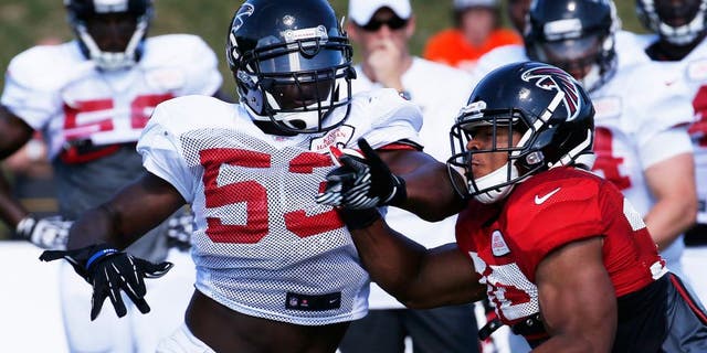 Atlanta Falcons linebacker Prince Shembo (53) works against Atlanta Falcons running back Josh Vaughan (30) during an NFL football training camp Monday, July 28, 2014, in Flowery Branch, Ga. (AP Photo/John Bazemore)