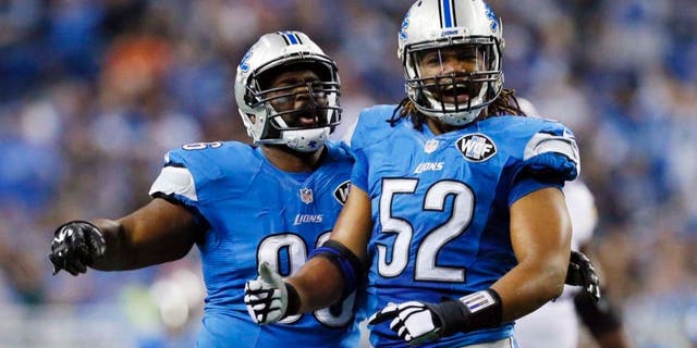 Detroit Lions defensive tackle Andre Fluellen (left) and defensive end Darryl Tapp react after their sack of Minnesota Vikings quarterback Teddy Bridgewater during the first half.