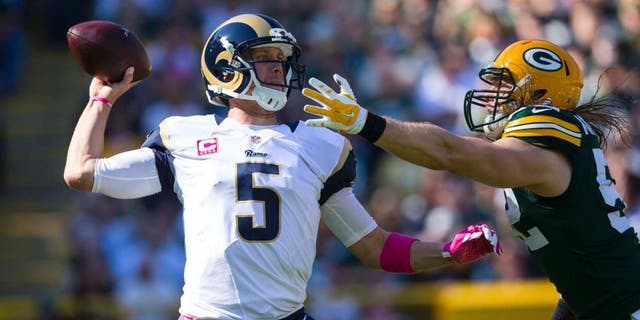 St. Louis Rams quarterback Nick Foles throws a pass under pressure from Green Bay Packers linebacker Clay Matthews during the first quarter at Lambeau Field in Green Bay, Wis., on Sunday, Oct. 11, 2015.