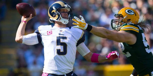 St. Louis Rams quarterback Nick Foles throws a pass under pressure from Green Bay Packers linebacker Clay Matthews during the first quarter at Lambeau Field in Green Bay, Wis., on Sunday, Oct. 11, 2015.