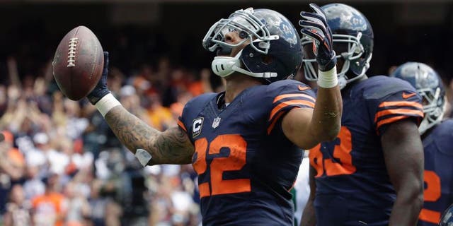 Chicago Bears running back Matt Forte celebrates a touchdown during the first half of an NFL football game against the Green Bay Packers, Sunday, Sept. 13, 2015, in Chicago.