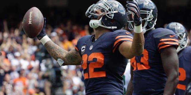 Chicago Bears running back Matt Forte celebrates a touchdown during the first half of an NFL football game against the Green Bay Packers, Sunday, Sept. 13, 2015, in Chicago.