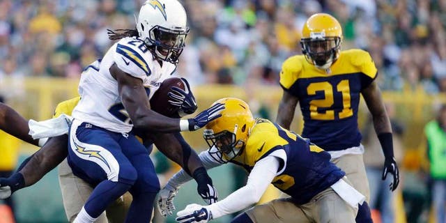 San Diego Chargers running back Melvin Gordon is tackled by the Green Bay Packers' Micah Hyde during the first half Sunday, Oct. 18, 2015, in Green Bay, Wis.