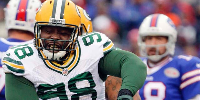 Green Bay Packers nose tackle Letroy Guion celebrates a sack of Buffalo Bills quarterback Kyle Orton (back) during the first half.