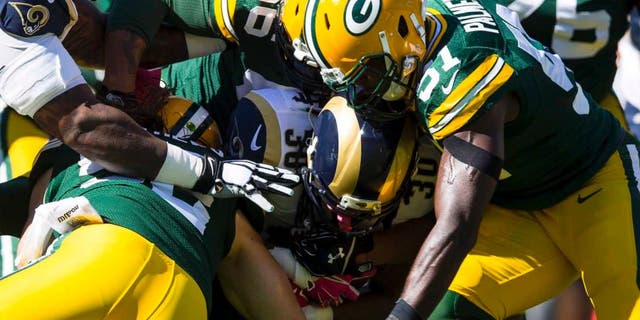 St. Louis Rams running back Todd Gurley is tackled with the football during the first quarter against the Green Bay Packers at Lambeau Field in Green Bay, Wis., on Sunday, Oct. 11, 2015.