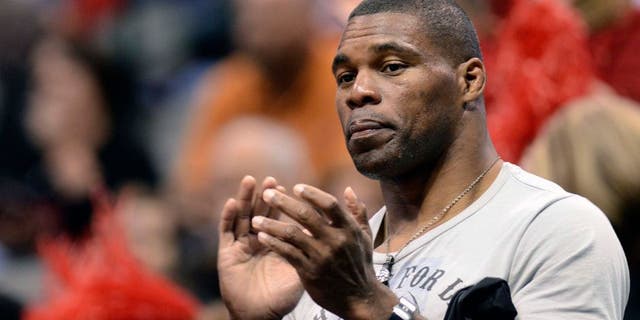 Mar 27, 2011; Dallas, TX, USA; Georgia Bulldogs former football player Herschel Walker cheers during player introductions before their game against the Texas A&M Aggies during the semifinals of the Dallas regional of the 2011 NCAA women's basketball tournament at the American Airlines Center. Mandatory Credit: Matt Strasen-USA TODAY Sports