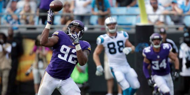 The Minnesota Vikings' Tom Johnson intercepts a Carolina Panthers pass in the second half in Charlotte, N.C., Sunday, Sept. 25, 2016. The Vikings won 22-10.