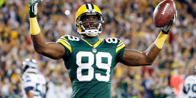 The Green Bay Packers' James Jones celebrates a touchdown catch during the first half of an NFL football game against the Seattle Seahawks on Sunday, Sept. 20, 2015, in Green Bay, Wis.